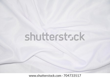 Texture, background, pattern. White cloth background abstract with soft waves, great for dresses or suits, where transparency and flow are required.