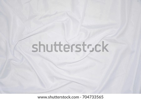 Texture, background, pattern. White cloth background abstract with soft waves, great for dresses or suits, where transparency and flow are required.