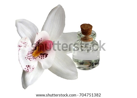 bottle of essential oil and orchid flowers, isolated