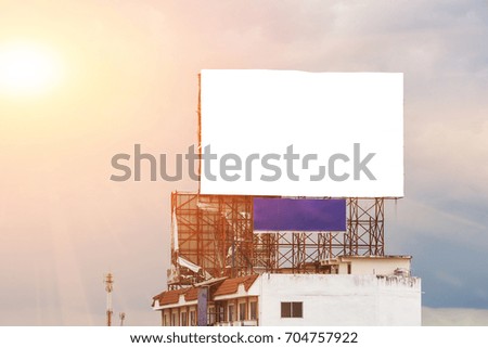 blank white billboard put on the building at sunset - can advertisement for display or montage text free space product and business.