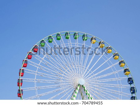 Colorful Ferris Wheel with Bright Blue Sky Royalty-Free Stock Photo #704789455