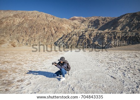Photographer in Death Valley, Badwater Basin Salt Flats, California, USA 
