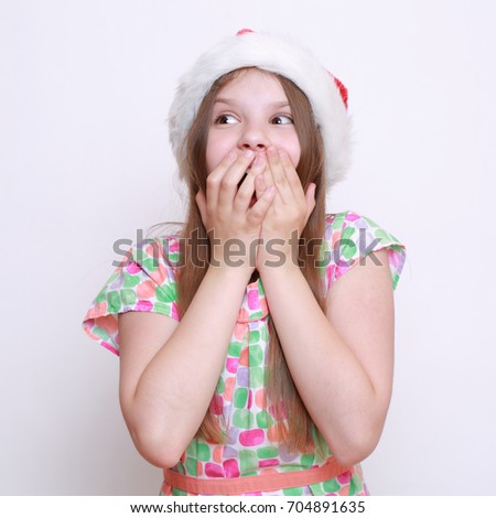 Pretty teen girl in santa hat on Holiday theme
