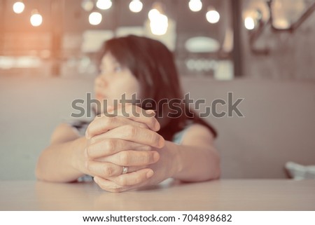 woman praying in morning. Hands folded in prayer
