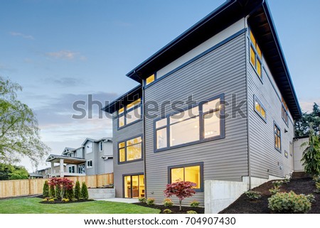 Luxurious contemporary three-story wood siding home exterior in Bellevue. Northwest, USA Royalty-Free Stock Photo #704907430