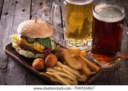 fast food menu with hamburger, , french fries and beer on wooden background