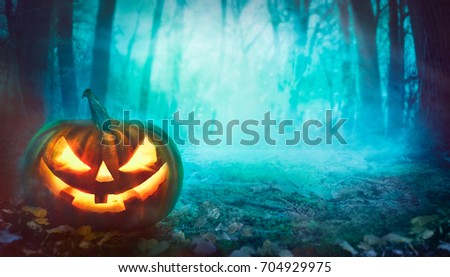 Halloween background. Spooky forest with dead trees and pumpkin.Halloween design with pumpkin