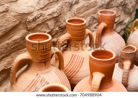 Amphoras, vases and old clay jugs in a rural house Royalty-Free Stock Photo #704988904