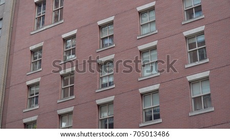 Generic red brick building exterior establishing shot for outside of urban city apartment school or office facility