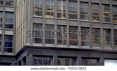Exterior of generic office building in large urban city. Day time outside establishing shot of many windows