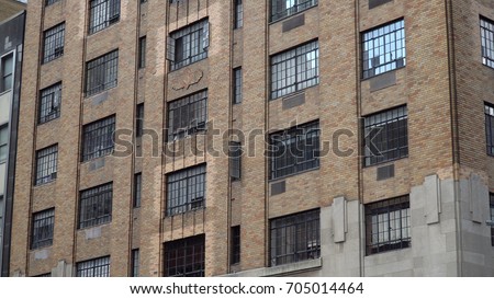 Typical exterior establishing photo of an urban city style brick apartment building facade during day time