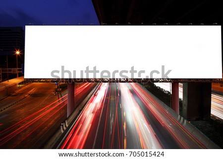 Blank billboard on light trails, night street and urban - can advertisement for display or montage product or business.