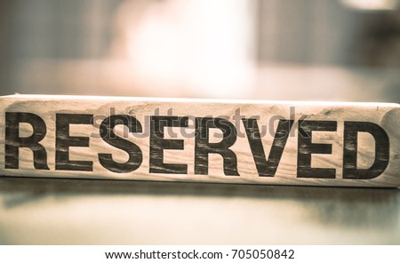 wooden sign saying reserved,close-up ,background ,concept hotels and restaurants