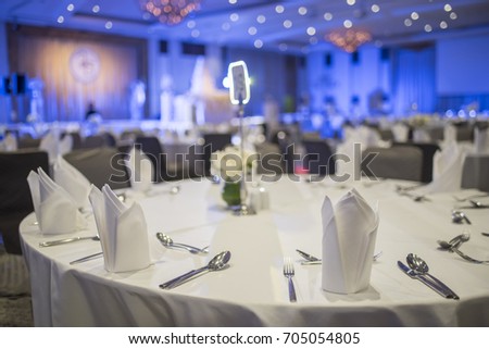 Dinner table in the banquet room of a luxury hotel. Royalty-Free Stock Photo #705054805