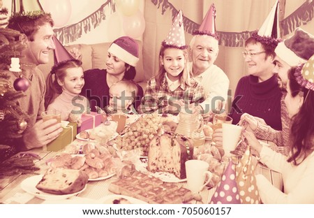 Large happy family celebrating childrenâ??s birthday during festive dinner