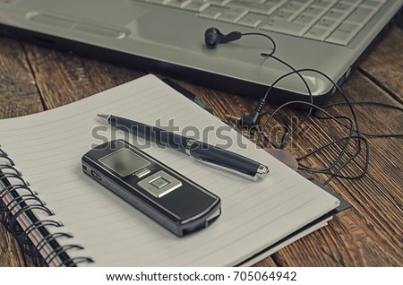 freelancer's work at a computer with a voice recorder Royalty-Free Stock Photo #705064942