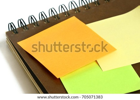 colorful post it paste on brown notebook on white background have copy space for put text to do list