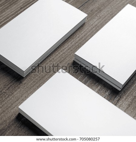 Stacks of blank business cards on wooden background.