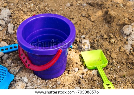 bright baby bucket and shovel in the sandbox