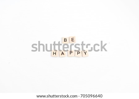 Quote Be Happy with wooden tiles on white background. Flat lay, top view