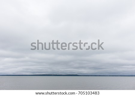 Background with low dark gray clouds cover the whole sky
