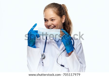Young doctor puts on a medical mask                               