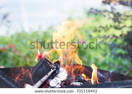 Coals are burned in a BBQ grill