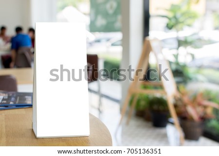 Mock up blank template menu frame on wood table in restaurant with blurred background, Clipping path included