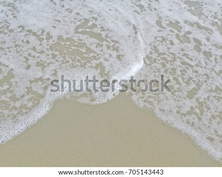 The sea have some wave and Bubble on the sandy of the beach, Thailand 