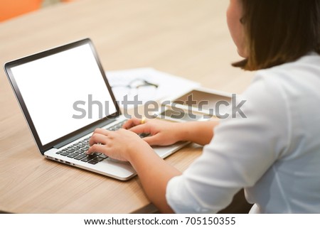 close up user employee woman hand working and typing at notebook mock up in office room concept Royalty-Free Stock Photo #705150355