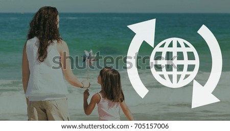 Digital composite of World with arrows icon against beach background