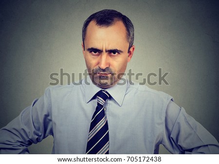 Angry displeased mature business man looking at camera 
