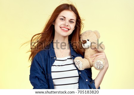 Girl with a smile in her hand a soft toy                               