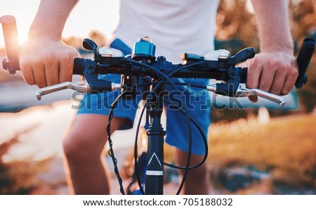 Man with a bicycle in the park, close up photo. Sport and recreation concept