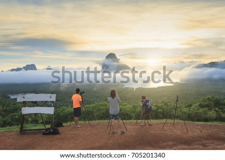 group of photographer taking landscape photo of fog background with island and nature view