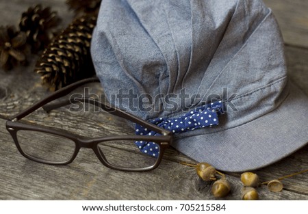 cap and cones on wooden background