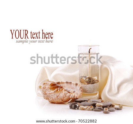 burning candle with sea shells and sea stones on a white background