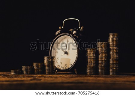 business financial ideas concept with coins stack and alarm clock isolate background with free copyspace for your creativity ideas text