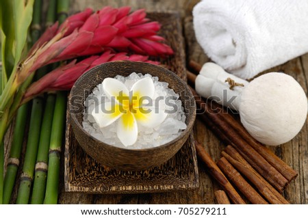 Tropical Spa setting ,with ,towel, plant with bamboo, ginger flower ,ball, on mat 