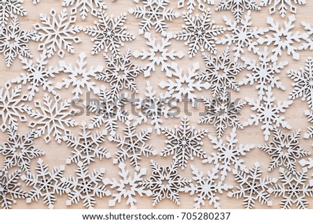 White Wooden Decorative Snowflakes on wooden Background, the Christmas Decor.