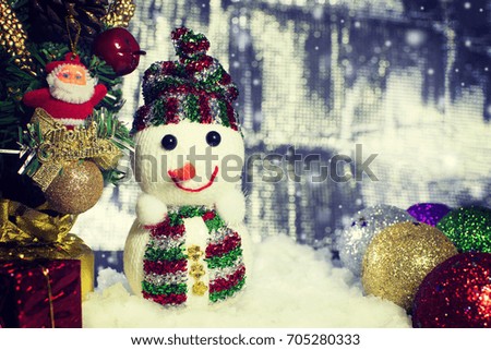 Merry Christmas and Happy New Year concept, Close up of Snow man and Christmas tree with santa claus plastics and accessories hanging on a christmas tree with snowflake below and copy space.