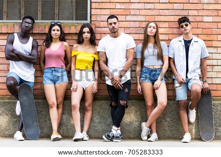 Portrait of group of young hipster friends looking at camera in an urban area.
