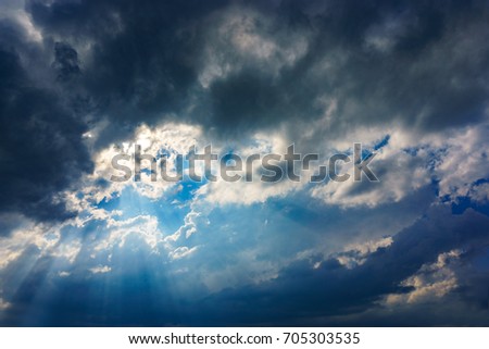 Sun rays breaking through thunderclouds