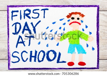 Photo of  colorful drawing: Words FIRST DAY AT SCHOOL and sad crying little boy