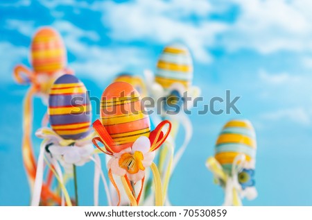 Colorful easter eggs with ribbons on blue background