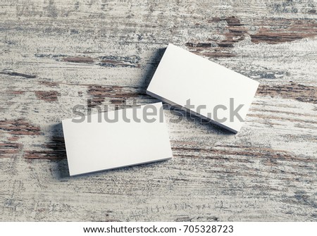 Blank white business cards on wooden background. Mock-up for branding identity.