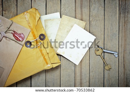 Vintage Envelopes with empty photos and keys on a wooden table