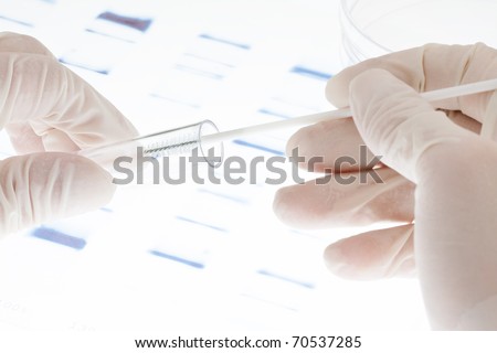 Researcher putting sample of DNA test into a test tube Royalty-Free Stock Photo #70537285