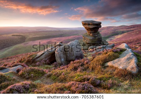 Stunning sunset over the Salt Cellar a weathered rock formation on Derwent Edge high above the Ladybower Reservoir in the Upper Derwent Valley in the Derbyshire Peak District Royalty-Free Stock Photo #705387601