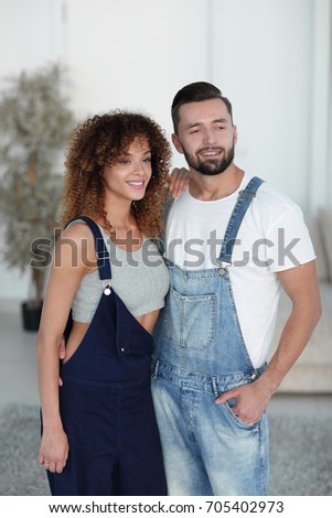 beautiful young couple standing in a new apartment. Photo has a 